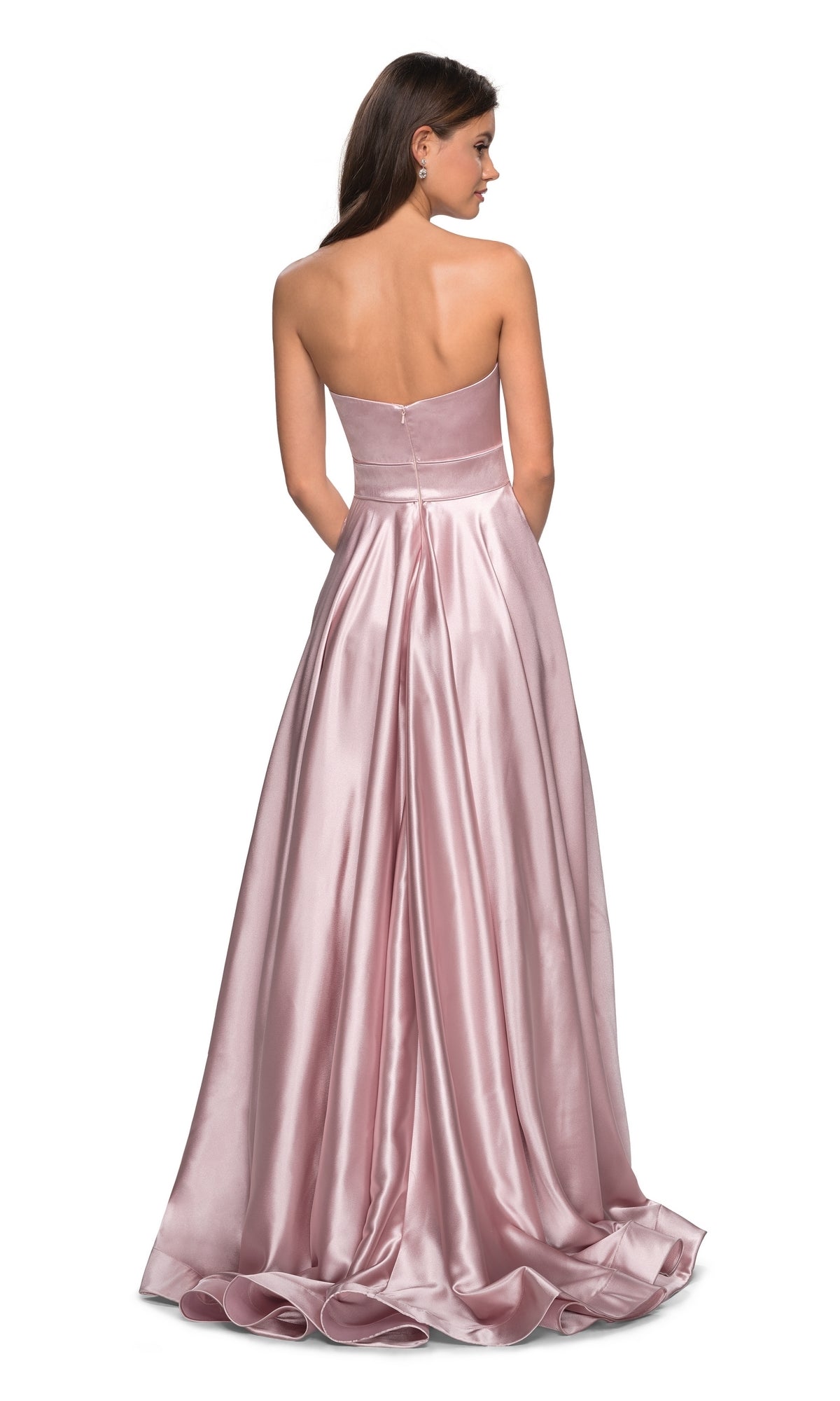 A woman models the Strapless A-Line Satin Prom Dress: La Femme 27506, shown from the back. The floor-length pink satin gown flows elegantly as she stands with her arms at her sides against a white background.